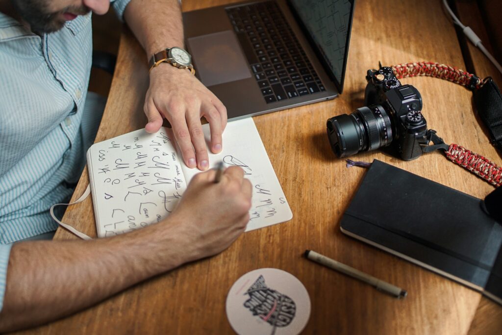 man drawing fonts at a desk